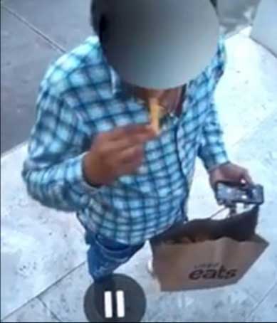 A delivery driver helps himself to your fries.