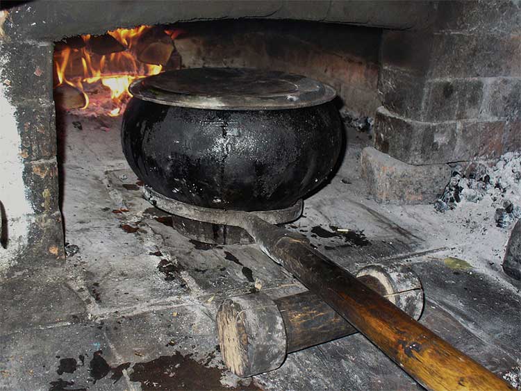 A traditional chugukok and the long-handled tool used to remove it from the hearth. An example of another culture's dutch oven.