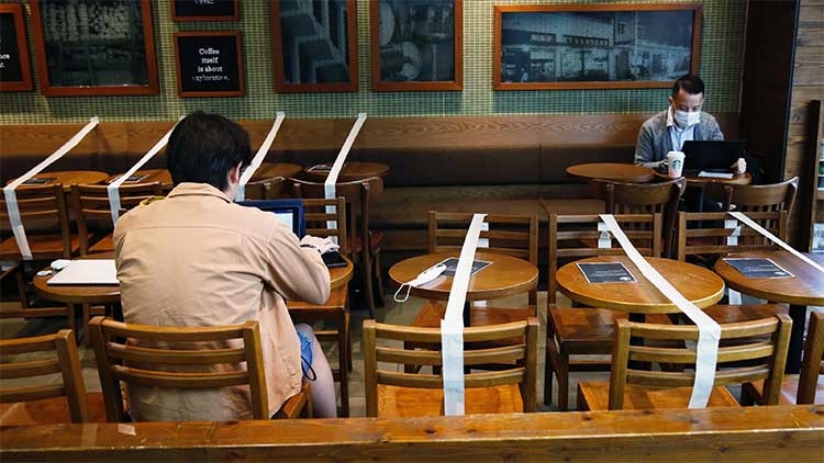 Using masking tape to block off table to enforce social distancing can work, but you might want to consider other options that are more professional-looking. (Reuters - Tyrone Siu)