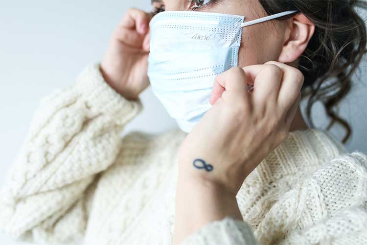 Properly position your disposable mask so that it covers your nose, mouth, and chin.