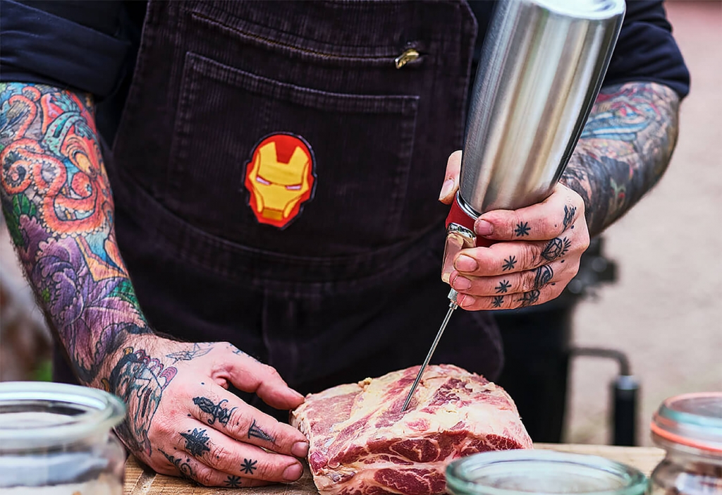 Chef Messina preparing injecting marinade with an iSi injector tip and whipping siphon.