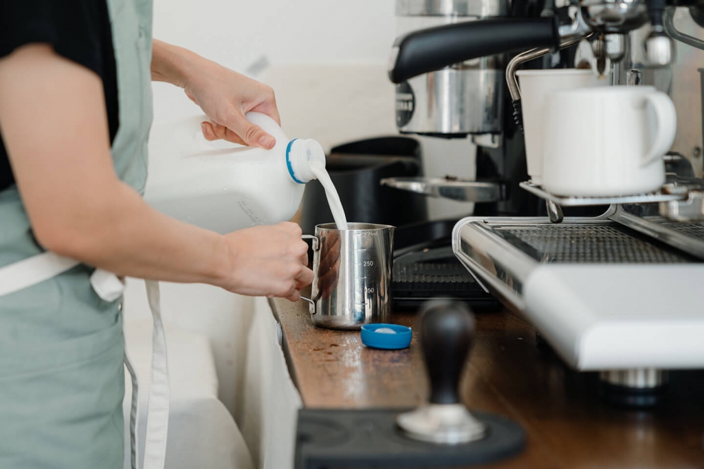 Man pouring potentially deadly milk into a container. 