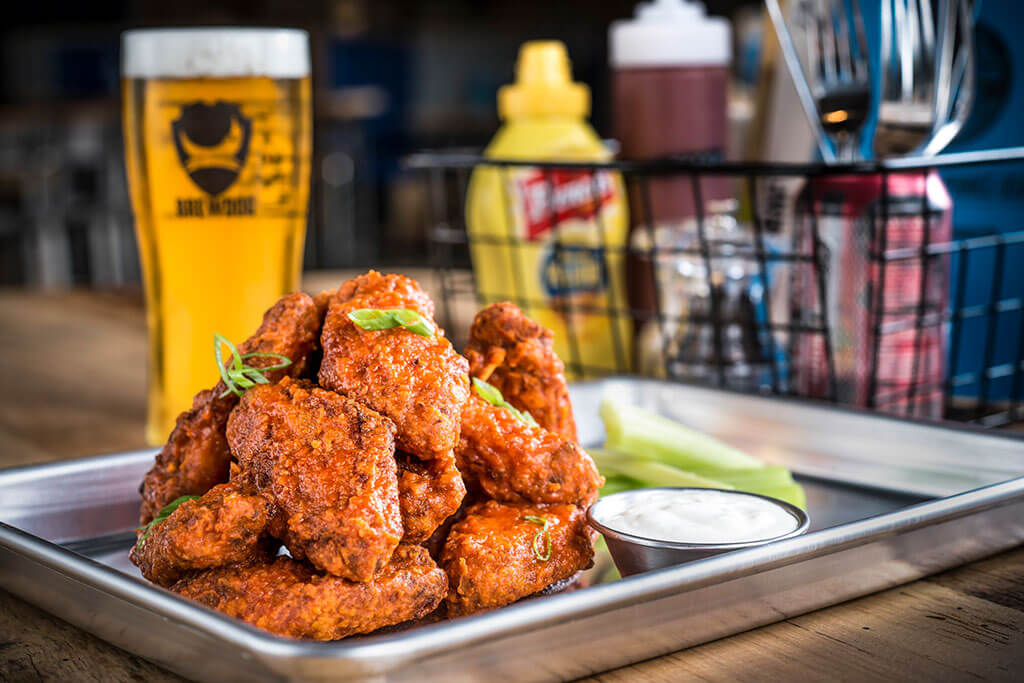 Food photography of chicken wings in a restaurant setting.