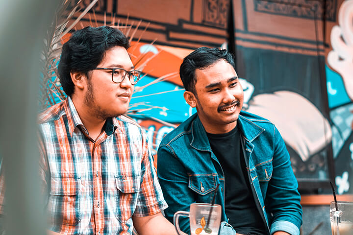 Two men enjoy their meal.