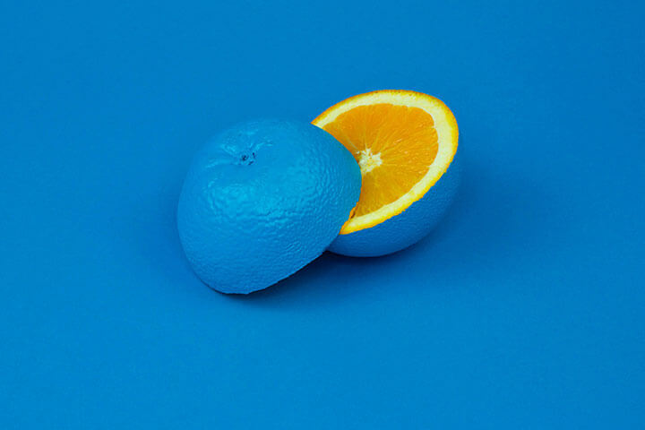 An orange fruit painted blue. 
