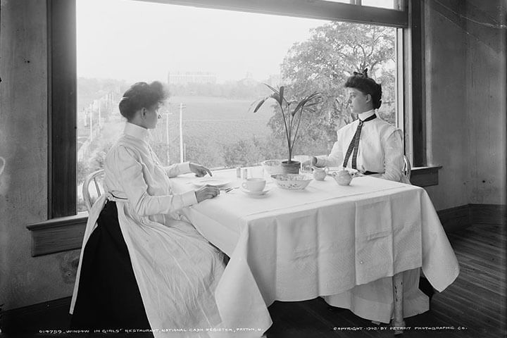 Two women dine in a segregated restaurant.