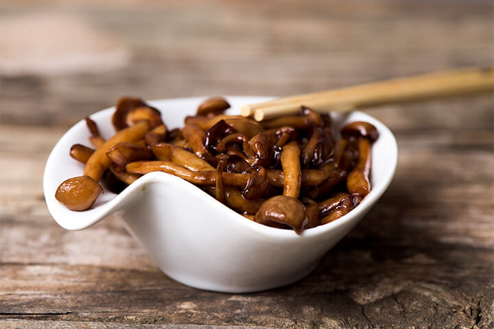 Sautéed Japanese bunapi-shimeji mushrooms presented as a rich umami side dish.