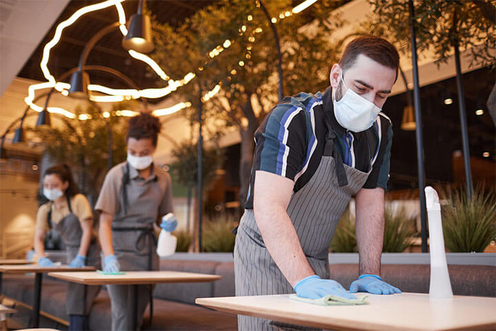 Three foodservice employees wearing PPE. 