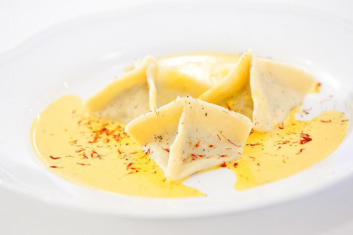 Ravioli with a saffron garnish.