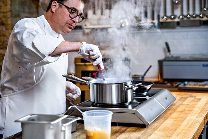 A chef uses Vollrath induction cookware.