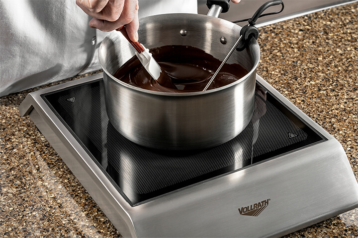 A chef mixes delicious chocolate.