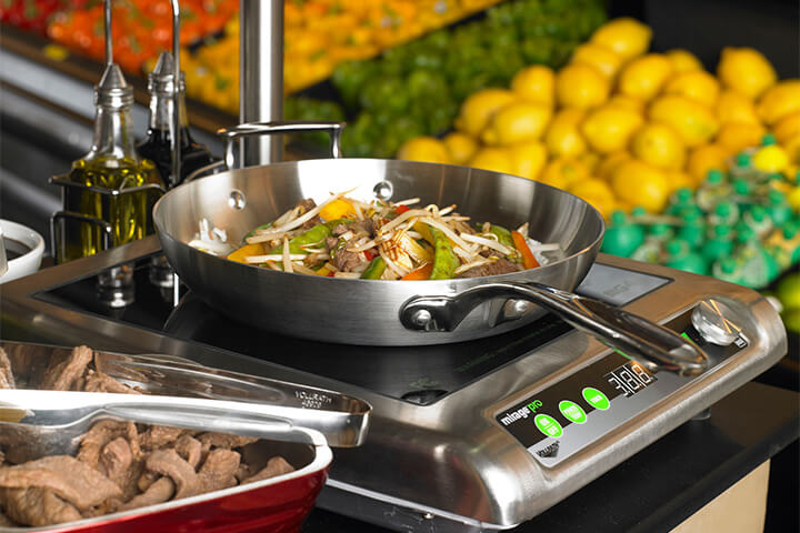 Induction cooking on display at a supermarket.