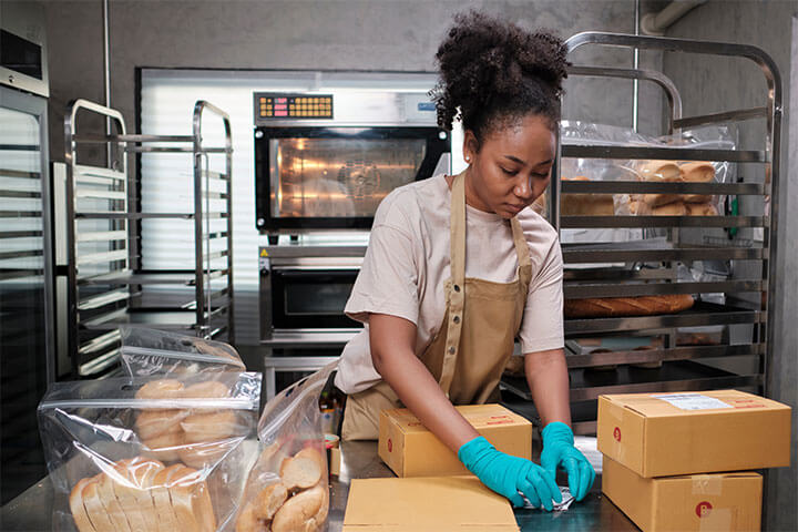 A woman works with baked goods.