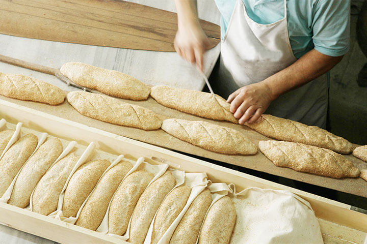 A man slices bread. 