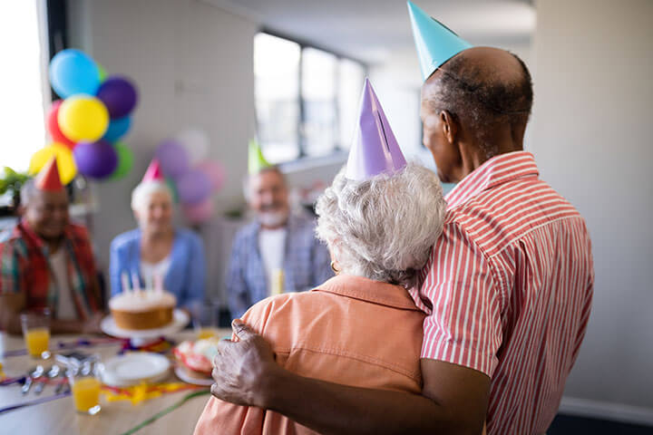 Photo of a birthday party at a senior living establishment.