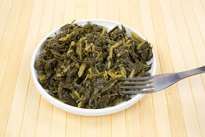 Collard greens in a bowl. Learn about them at the Soul Food Museum.