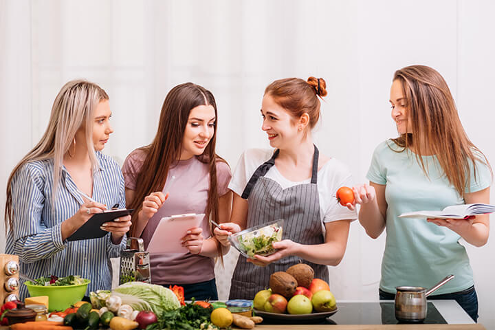 A group of white women learn to cook. While convenience is king, Gen Z and Millennials also love an experience, especially if it goes hand-in-hand with healthy options.