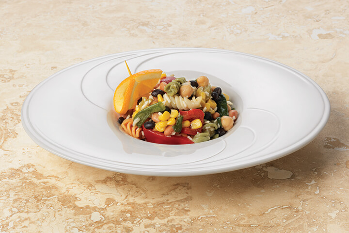 Wide-rimmed, shallow bowls are an excellent and easy way to incorporate negative space into your plating. 