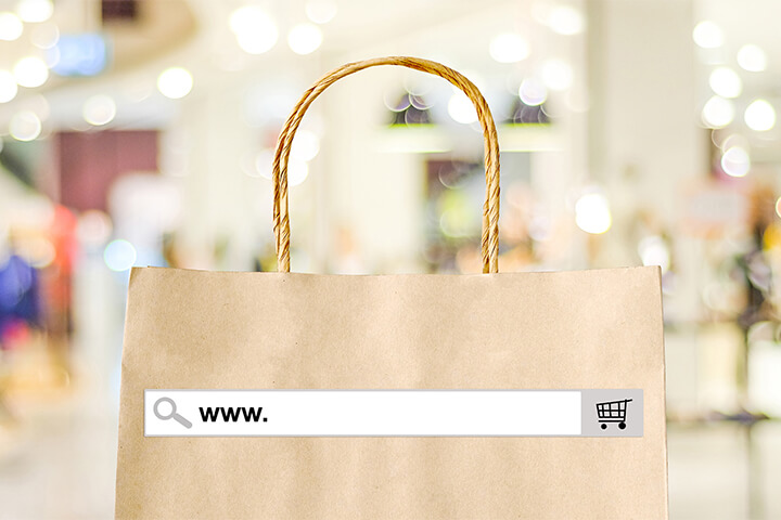 A shopping bag has a placeholder for a url, indicating the importance and omnipotence of technology.