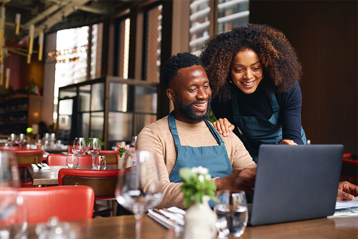 A happy couple look at their online reviews.