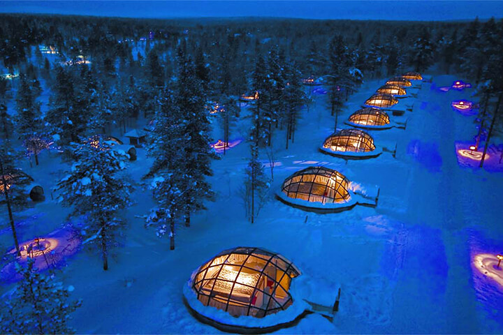Glass igloos on snowy terrain. Unconventional hotel.