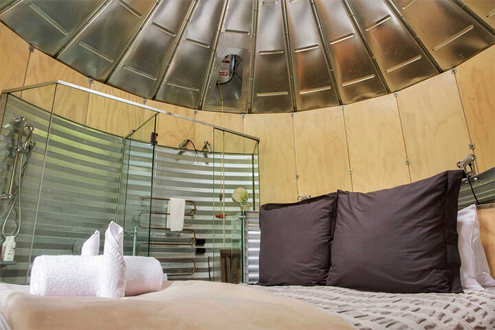 View of the silo interior including a bed and shower.