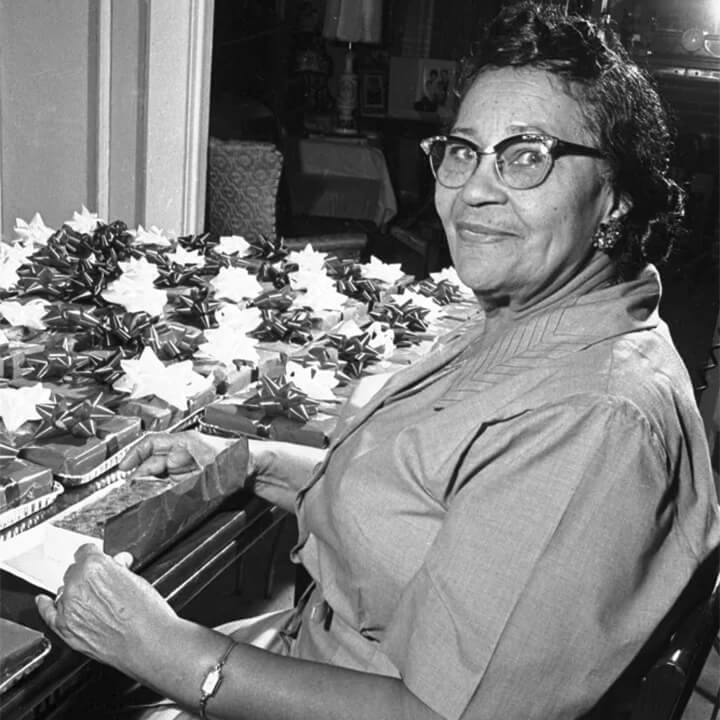 Photo of Lucille B. Smith wrapping packages.