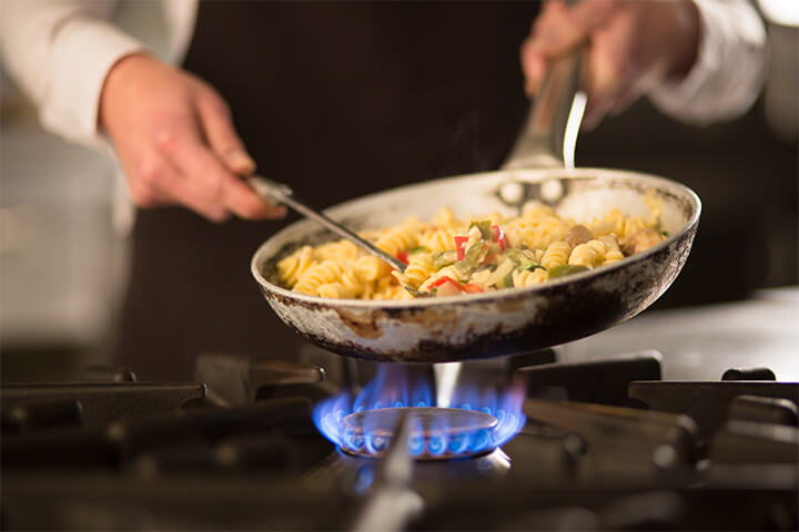 Cooking a pasta dish.