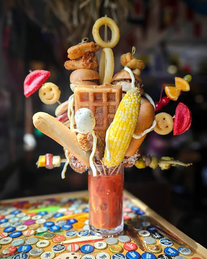 Photo courtesy of Smashed On The Rocks Saloon in Algoma, WI. The drink includes a footlong hotdog, burgers, and other comfort-food favorites.