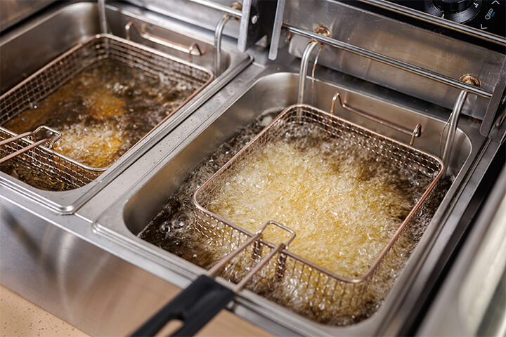 A fryer with bubbling oil.
