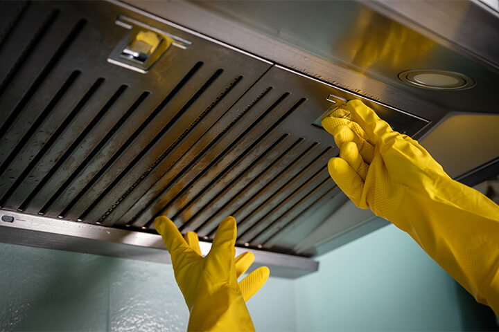 A hood with gloved hands.