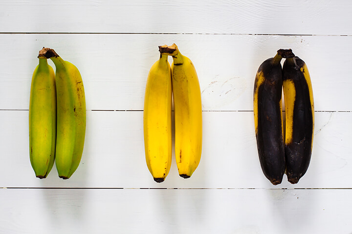 Three bananas at various stages of life.