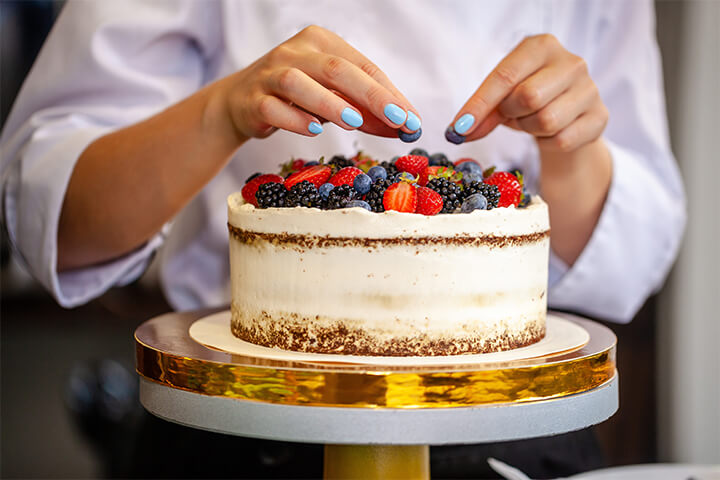 A beautiful cake topped with berries.