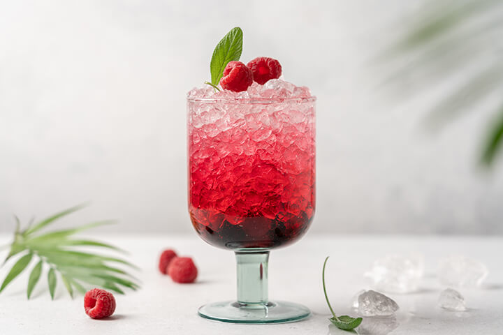 Crushed ice in a dazzling raspberry beverage.