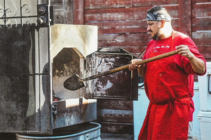 A man using bbq equipment.