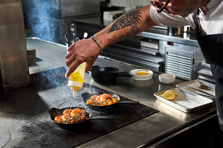 Le Creuset's Gourmand collection with a shrimp dish.