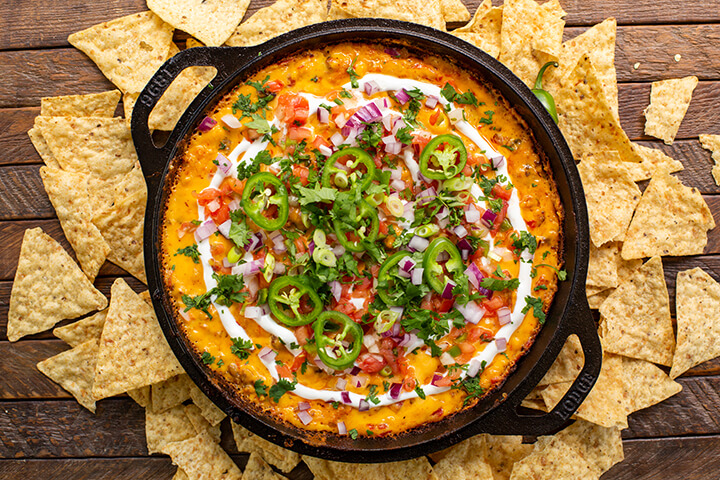 Next-level queso prepared in a Dual Handled Cast Iron Skillet. Lodge Cast Iron's cookware is nontoxic and made without PFAS. 