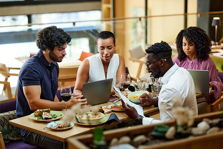 A group of young business people working in a restaurant.