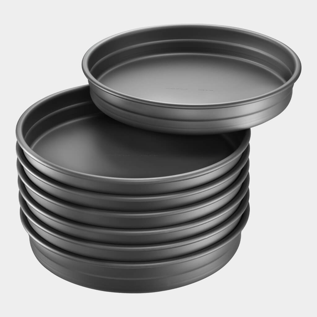 A stack of Exact Stack pizza pans by Chicago Metallic. 