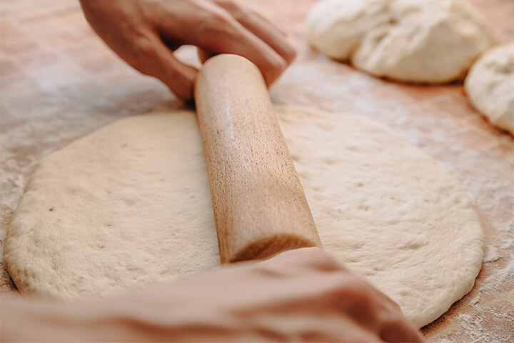 Someone manipulating dough.