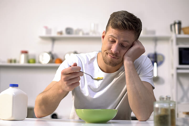Man is dismayed by breakfast.
