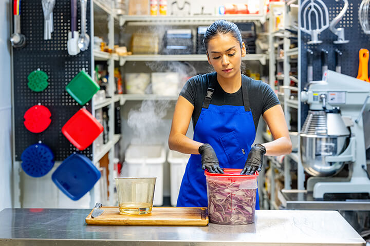 A woman preps onions.