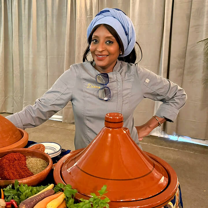 Chef D standing behind a tagine.