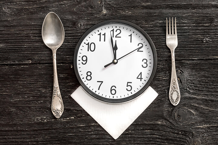 A clock being used as a dinner plate. 
