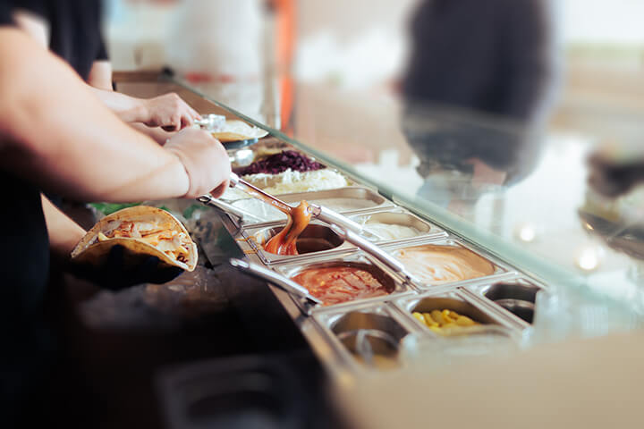 A man scoops out the secret sauce.