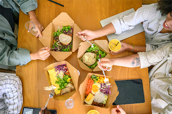 A group of associates eat lunch together.