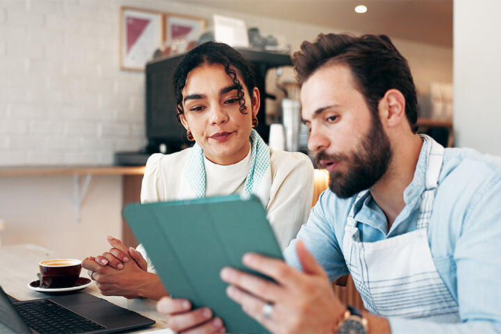 A man acts like a professional while he speaks to a health inspector.