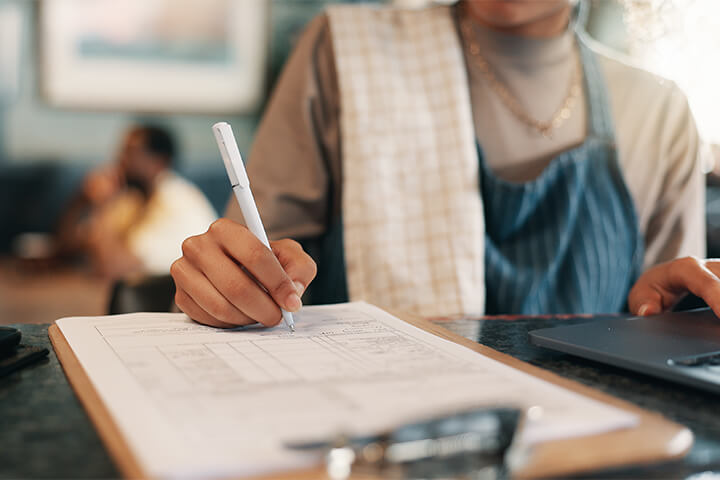 A woman diligently logs some records.