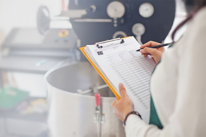 A woman logs data in the kitchen.