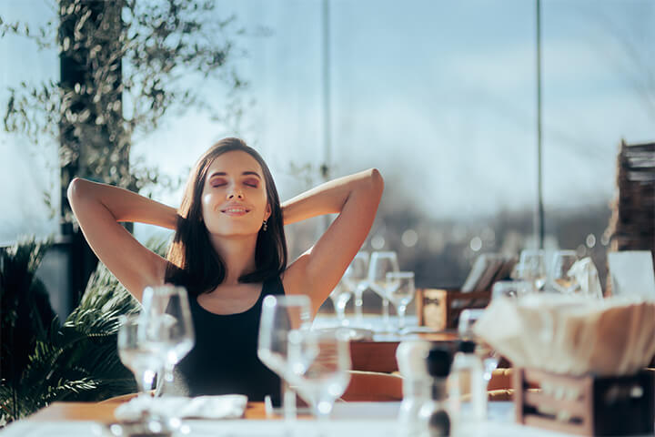 A lady finds a moment of peace in a restaurant with a phone ban.